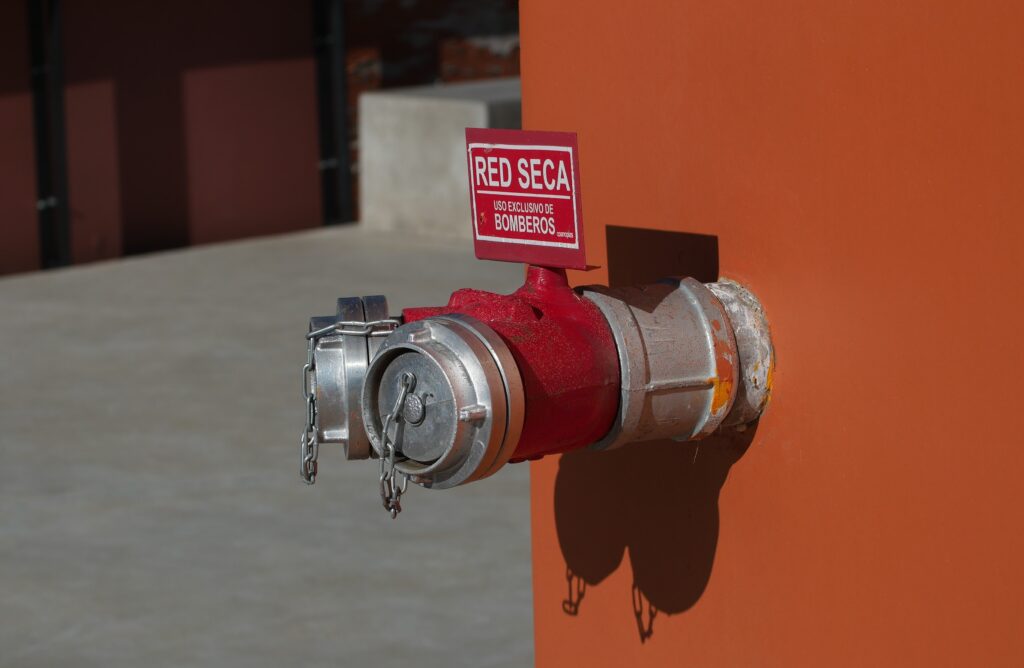 Fire hydrant water supply during emergency hooked to hose at day